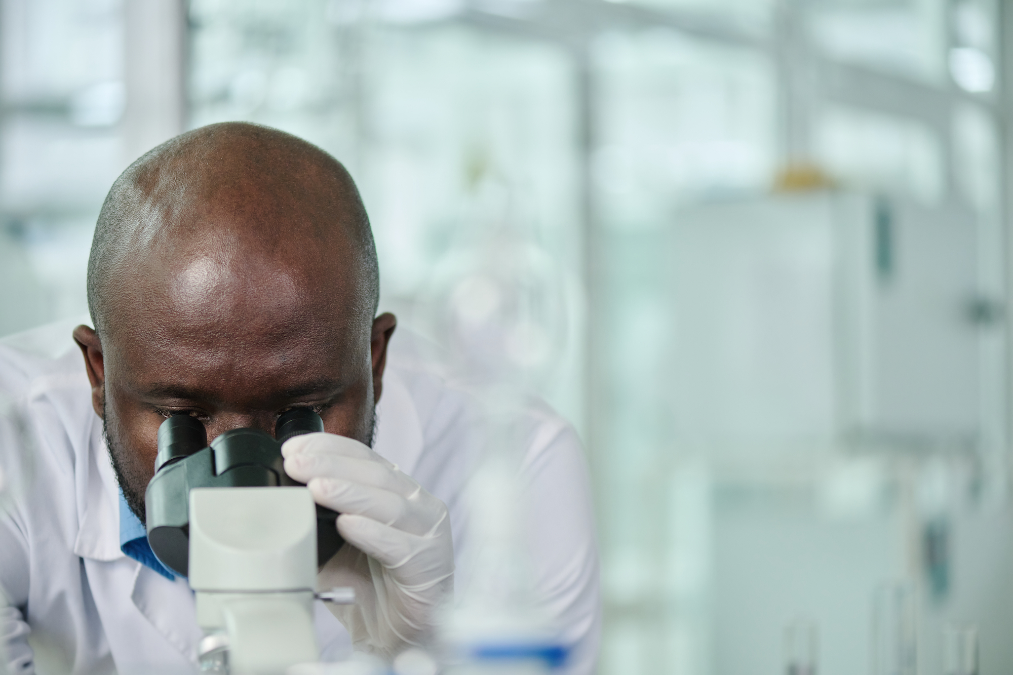 Pathologist looking through microscope